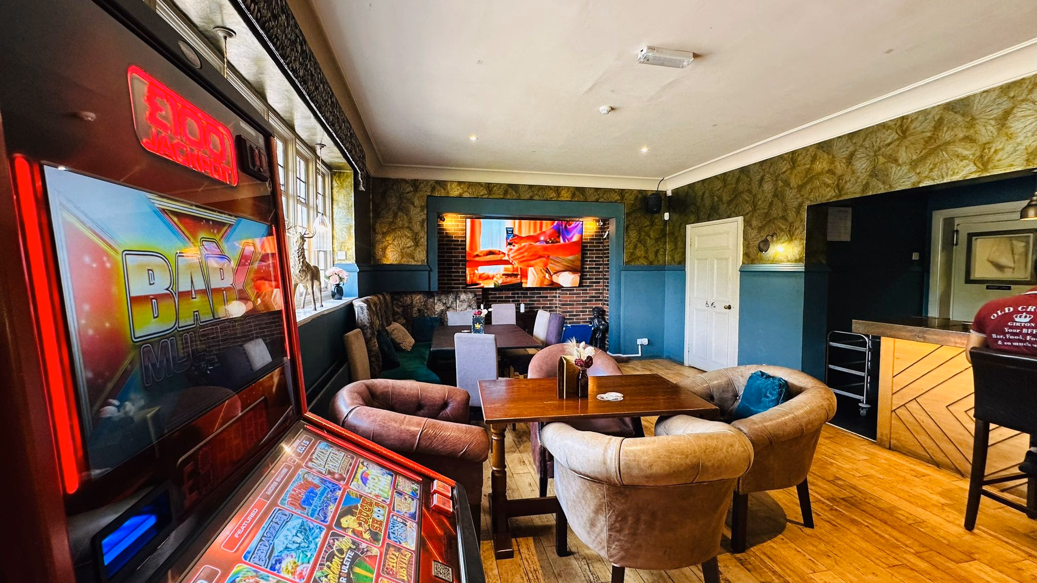 Comfortable bar lounge with armchairs and TV for sports viewing at Old Crown Girton